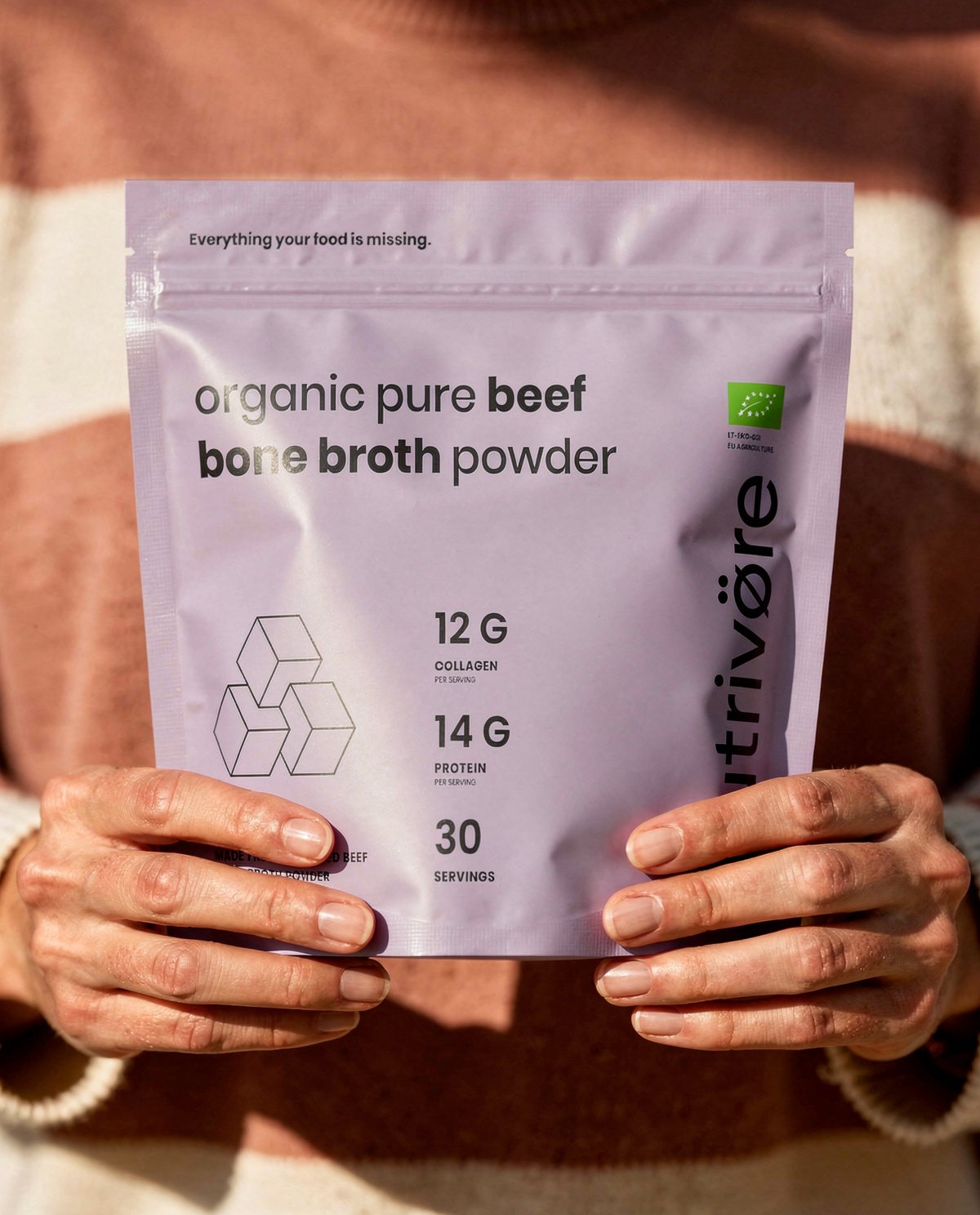 Nutriōteca Organic Bone Broth Powder held in hand
